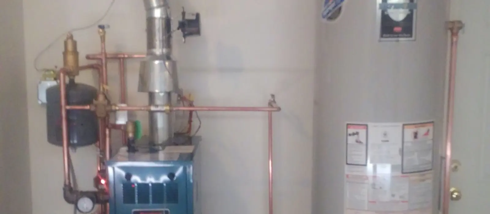 A traditional Bradford White tank water heater installed by Rapid City Plumbing