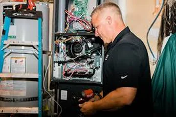 Technician servicing a furnace