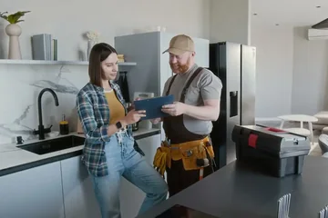 Plumber talking with a homeowner